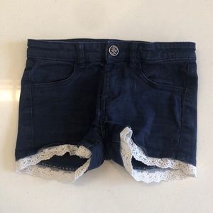 Casual shorts. Ages 5-6. Dark blue with white trim on the bottom.